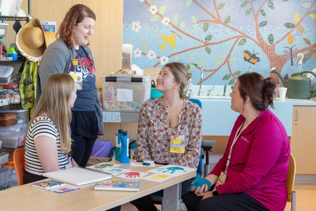 Art therapists at a children's hospital sitting at a table and working together