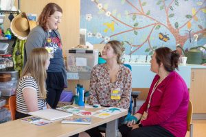 Art therapists at a children's hospital sitting at a table and working together